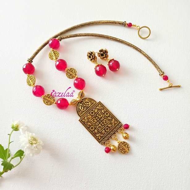 Pinkish red gemstone designer golden necklace earrings set